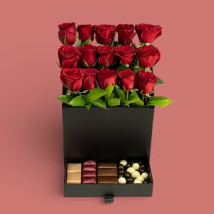 A luxurious flower box containing a variety of red roses